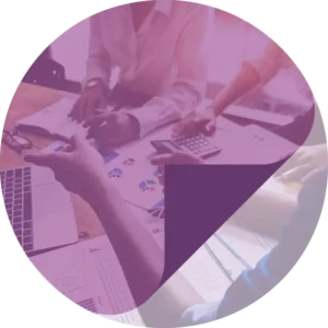 Workers sat at desk with paperwork and calculators